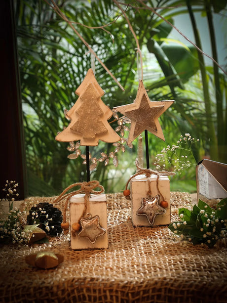 Set of wooden star decor with silver foiling in white and silver finish.