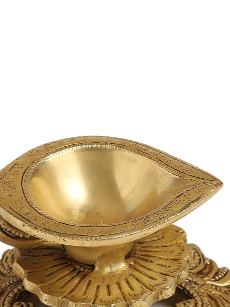 Ornate brass diya with a decorative base and handle, designed for a graceful, classic aesthetic.