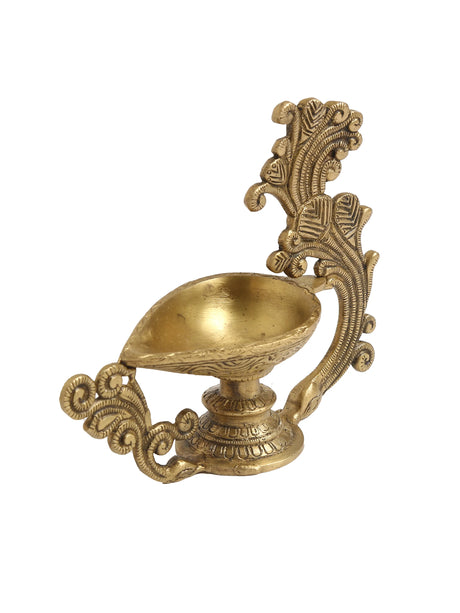 Decorative brass diya with ornate handle showcasing traditional craftsmanship.
