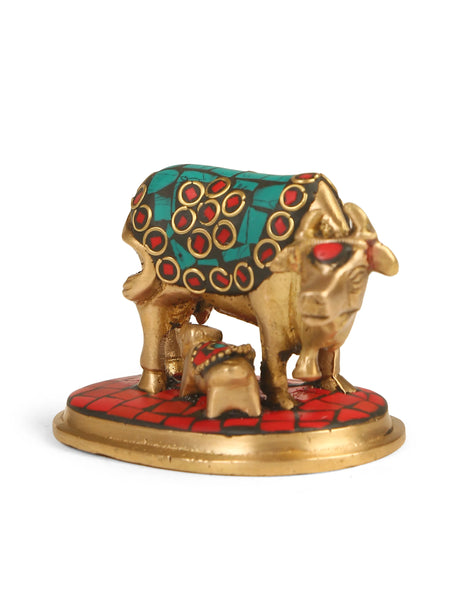 Brass Kamdhenu with calf, intricately detailed with turquoise, red, and blue stone work.