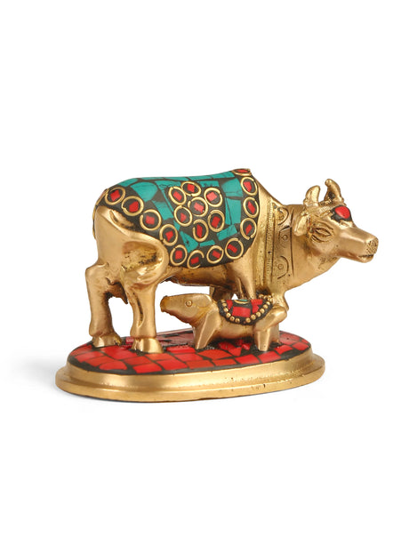 Antique gold Kamdhenu brass statue with calf and colorful stone accents.