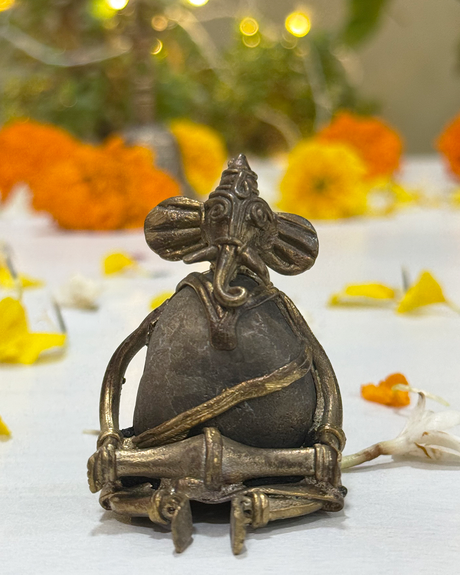 Close-up of handcrafted Musician Ganesha Dhokra art statue in antique brass.