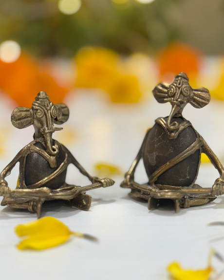 Decorative brass Lord Ganesha statues holding instruments, ideal for pooja room and festive decoration.