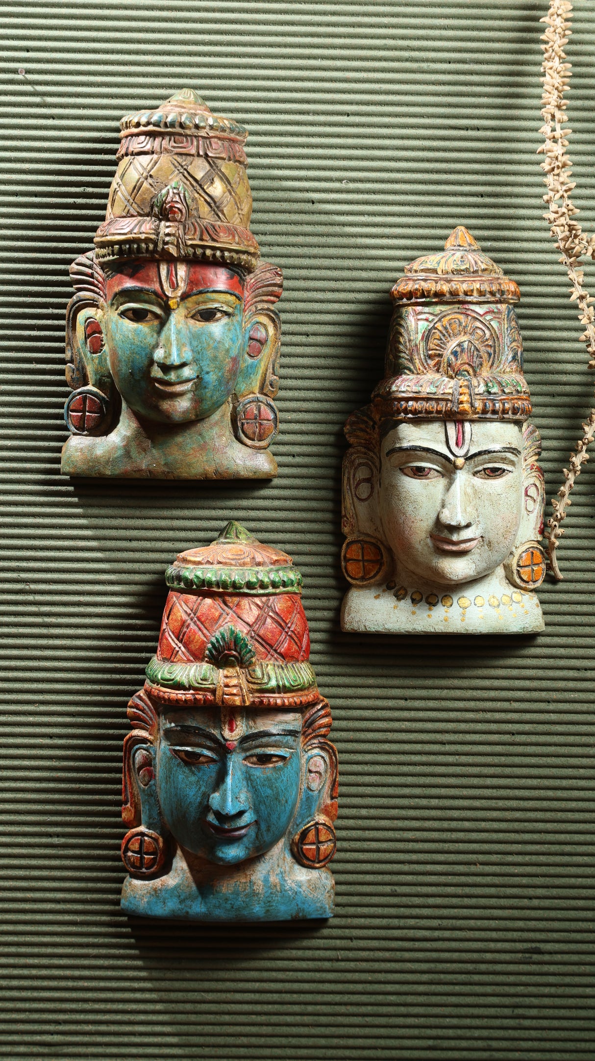 Handcrafted Vishnu masks in assorted colors, depicting serene expressions, symbolizing protection and the destruction of evil.