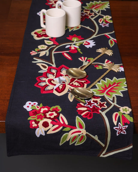 Embroidered black runner with flower pattern