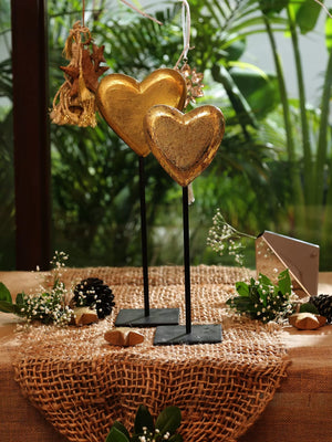 Decorative gold foiled heart accents crafted from mango wood and iron.