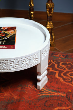 Wooden coffee table with white wash finish .